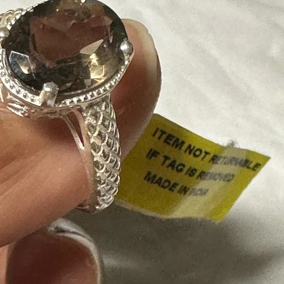 This is a sterling silver ring featuring a smoky quartz gemstone